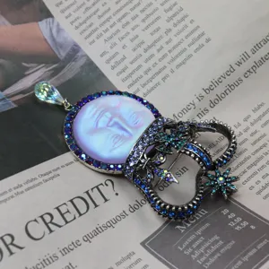 Vintage moon face crown brooch pendant, antique silver tone with blue rhinestones.