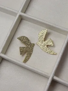 Gold textured swallow stud earrings detail view, showing exquisite niche designer jewelry style.