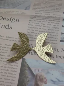 Vintage gold-colored bird shaped stud earrings, unique textured design jewelry for women daily.