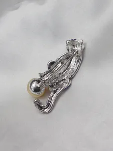 Vintage silver panther brooch detailed back view with sparkling crystal and pearl accent.