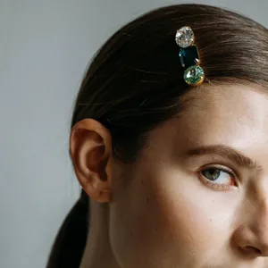 Close-up of a glamorous multi-color rhinestone hairpin detail, elegant and sparkling.