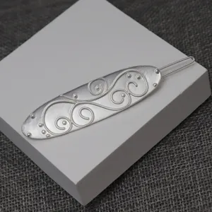 Exquisite detail view of the retro silver hair clip featuring intricate scrollwork and beads.