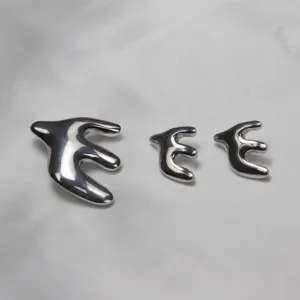 Silver liquid metal swallow brooch and earrings set, elegant jewelry accessory for women.