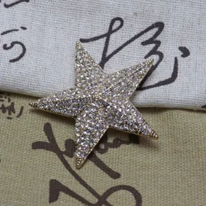 Vintage sparkling crystal rhinestone five pointed star brooch pin for suit hat and bag accessories.