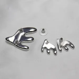 Silver abstract swallow brooch and earrings set, elegant metal jewelry accessory for women.