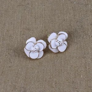 Exquisite white camellia enamel stud earrings with gold trim, vintage designer style detail.