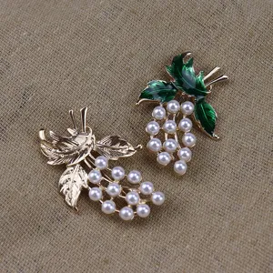 Detail view of vintage pearl enamel grape brooch, exquisite metal craft for retro outfit decor.