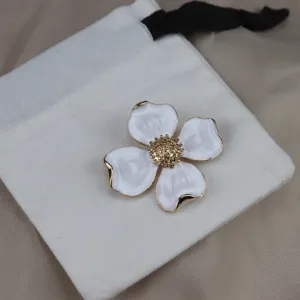 Vintage metal four-leaf clover flower brooch with elegant white enamel and gold tips.