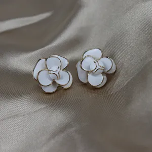 Elegant white camellia flower earrings closeup featuring delicate gold trim enamel finish detail.