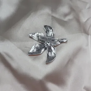 Detail view showing the reverse pin clasp of the exquisite enamel iris flower accessory.