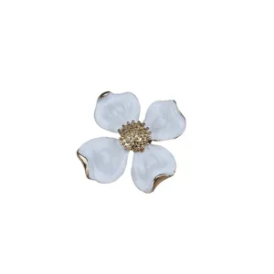 Vintage four-leaf clover brooch, elegant white enamel and gold-tone metal jewelry.