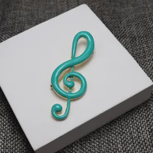 Elegant turquoise enamel treble clef music note brooch pin for music lovers and students.