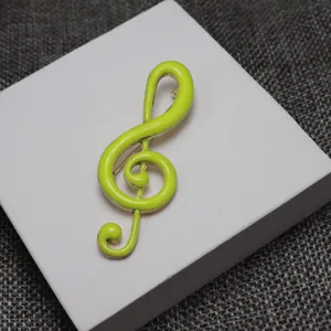 Green enamel treble clef music note brooch pin for students and music lovers apparel accessory.