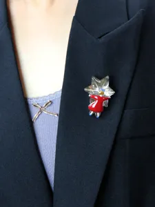 Close-up detail shot of the handmade red skirt girl hugging star brooch accessory.