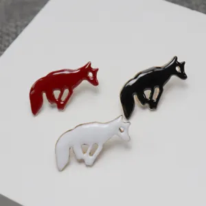 Detailed view of cute metal enamel galloping animal lapel pins in red black and white colors.