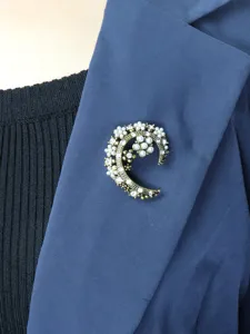 Vintage C-letter moon pearl rhinestone brooch detail shot, elegant lapel pin jewelry.