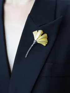 Elegant matte gold ginkgo leaf brooch with black crystal stem details for women fashion.