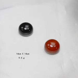 Close-up detail of natural agate magnetic brooch buttons in black and red gemstone cabochons.