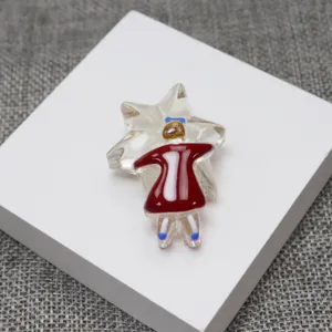 Handmade glass brooch featuring a cute girl in red dress hugging a star, unique indie design accessory.
