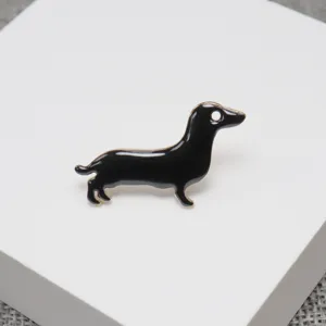 Cute black dachshund enamel brooch pin, metal lapel accessory for clothing, hats and bags detail.