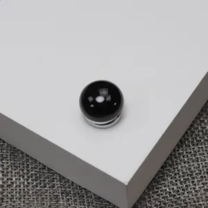 Close-up of black agate magnetic brooch, 14mm round stone with metal base for clothing.