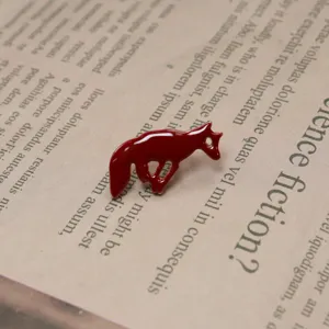 Detailed shot of a cute red fox enamel brooch, stylish animal lapel pin for bags.