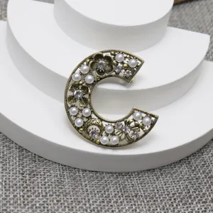 Vintage C letter pearl rhinestone brooch pin, elegant floral antique bronze fashion jewelry accessory.