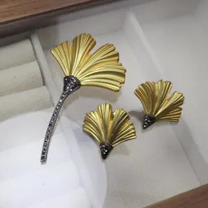 Ginkgo leaf jewelry detail view, vintage matte gold brooch and matching earrings set.