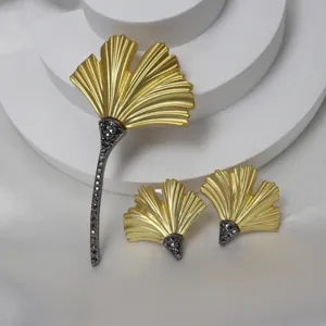 Vintage ginkgo leaf brooch earrings set matte gold finish with sparkling black rhinestone stem design.