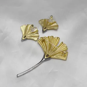 Ginkgo leaf brooch and earrings set, matte gold and silver tone alloy, vintage style jewelry detail view.