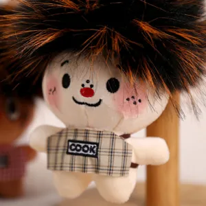 Close-up detail of the cute plush doll keychain, featuring fluffy afro hair and plaid apron.