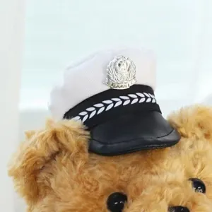 Close-up detail of a cute police uniform hat accessory on a plush teddy bear toy, soft texture.