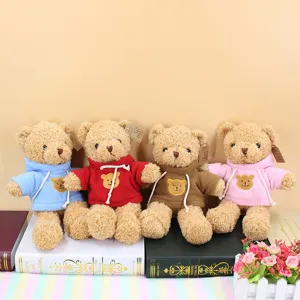 Detailed view of cute plush teddy bears wearing colorful hoodies, neatly arranged for home decor.