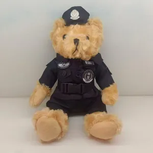 Detailed view of a cute brown teddy bear plush toy wearing a black police uniform and hat.