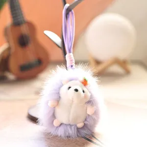 Close-up view of a cute plush hedgehog keychain with fluffy purple design details.