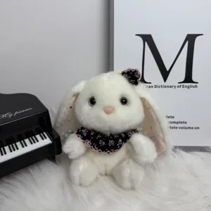 Cute white plush bunny toy featuring floral collar, soft long-eared rabbit doll detail.