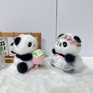 Close up detail of cute panda plush toy couple pendant with floral bouquet and dress