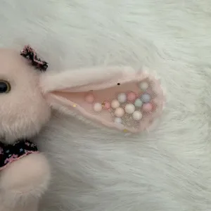 Cute long ear rabbit plush keychain detail view showing soft pink fur and mesh filled balls.