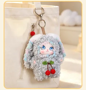 Cute curly plush rabbit doll bag charm detail showing soft vinyl face and cherry pendant style.