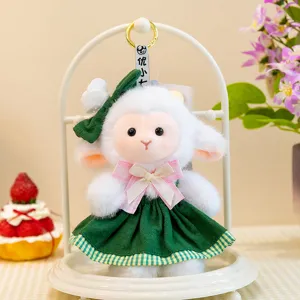 Cute cartoon lamb plush toy with green dress and pink bow, soft stuffed animal doll for kids.