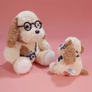 Cute puppy plush toy with glasses and camera, soft stuffed animal doll desktop companion gift.