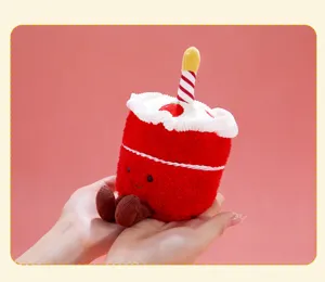 Cute birthday cake plush toy pendant with candle and dangling legs for keys or bag decor.