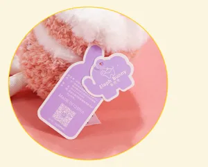 Close-up detail view of the cute cake plush pendant featuring brand tag and soft fuzzy fabric.