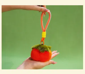 Cute plush persimmon keychain detail showcasing soft fluffy texture and vibrant orange color.