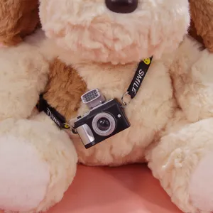 Cute plush puppy toy doll with mini camera pendant, soft stuffed animal gift for kids.