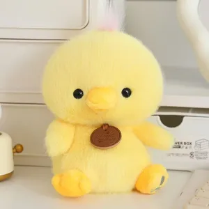 Cute yellow plush chick toy with fluffy pink hair and cute sitting design for kids.