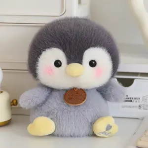 Close-up detail of the adorable soft plush penguin toy featuring gray fur and a wooden tag.