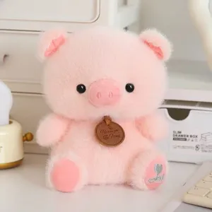 Close-up detail of the cute pink plush toy showing soft fabric, cute tag and embroidered foot.