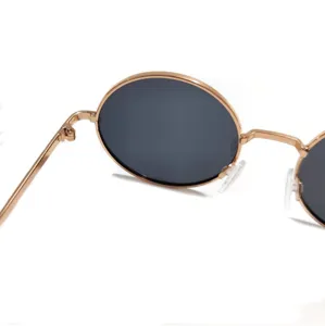 Close-up detail of retro round metal frame children sunglasses with dark polarized lenses.