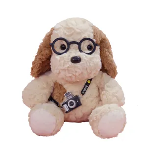Cute plush dog toy with round glasses and camera strap. Soft stuffed animal gift for kids.